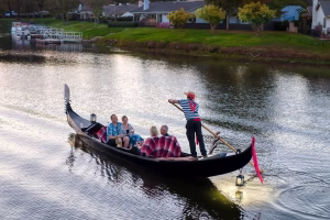 Gondola cruise on serene water with guests enjoying a romantic experience, showcasing Black Swan Gondola's premium dining offerings in San Diego.